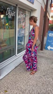 Magdalena Dubaj in a colourful dress looking at a shop window during a holiday in France.